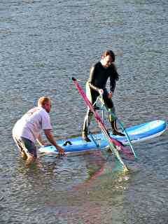 Standing and trying to pull the sail up